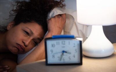 Software engineer working late at night while chronic sleep deprivation affects heart health