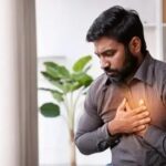 Corporate professional practicing breathing exercises to stimulate the vagus nerve and improve heart health