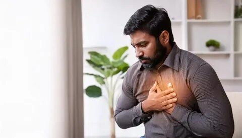 Corporate professional practicing breathing exercises to stimulate the vagus nerve and improve heart health