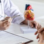 Cardiologist reviewing AI-powered IVUS and OCT imaging to determine whether a patient needs a heart stent or bypass surgery.
