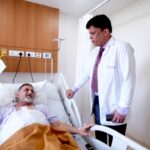 Senior patient undergoing TAVI procedure for severe aortic stenosis using minimally invasive heart valve replacement technology.