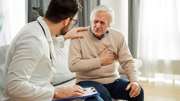 Cardiologist reviewing real-time heart monitoring data from wearable devices on a digital dashboard for remote patient care